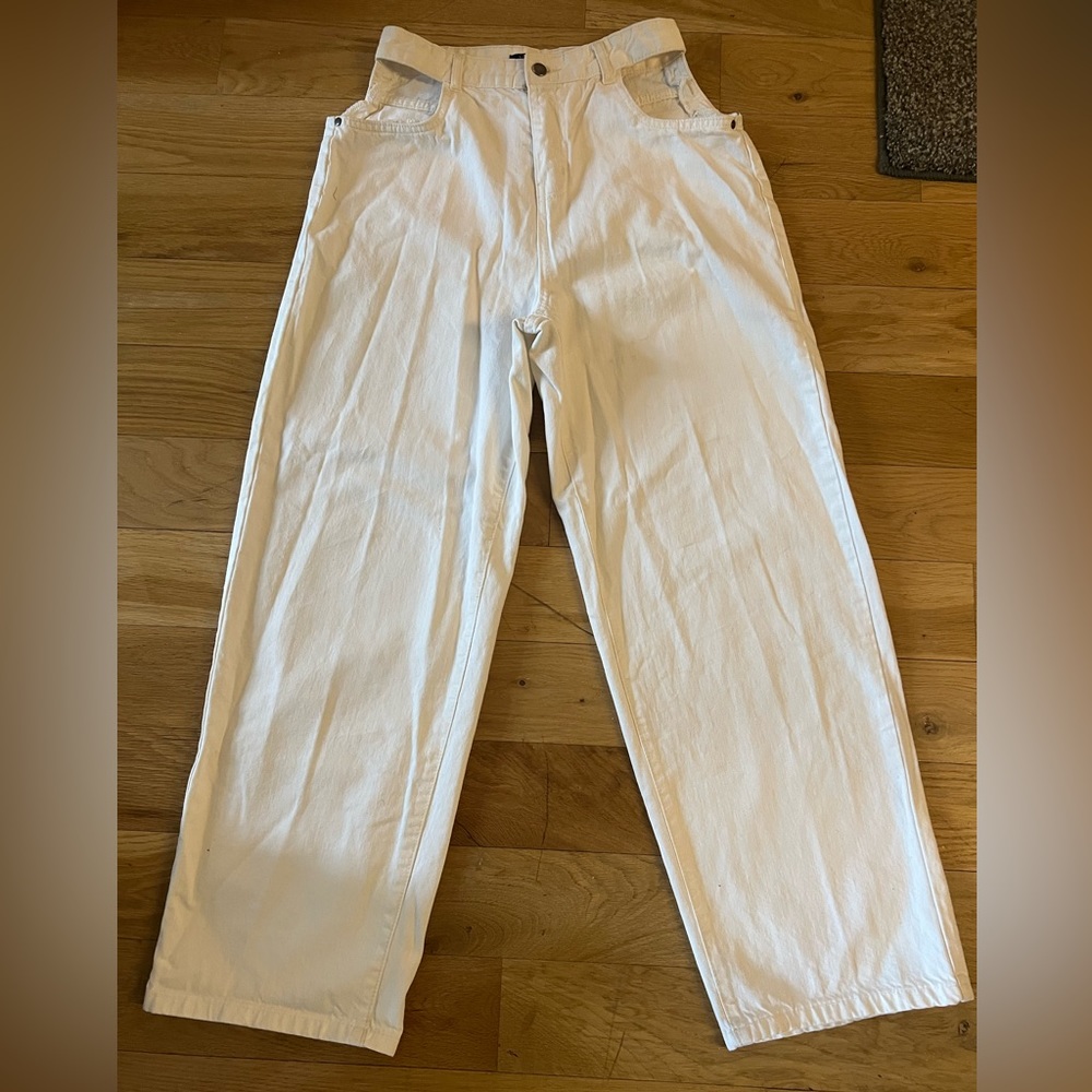 White straight leg jeans with hip cutouts